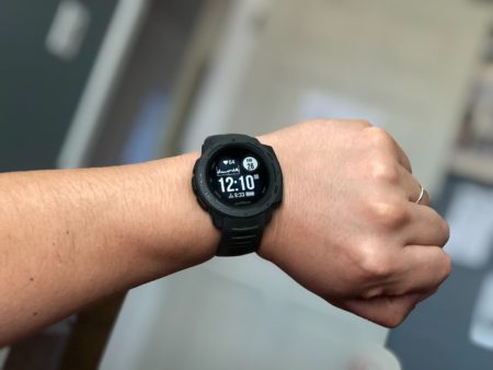 person wearing black garmin digital watch