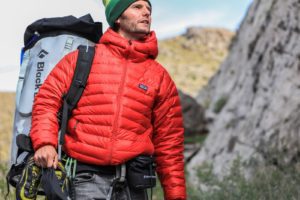 man looking above carrying gray patagonia backpack