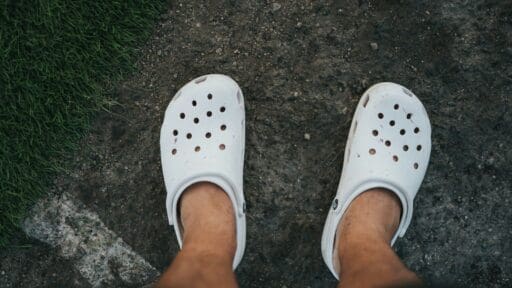 person wearing white rubber clog crocs