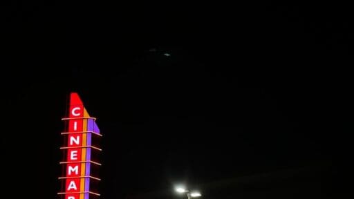 a large cinemark sign is lit up in the dark