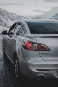 silver mazda car on road