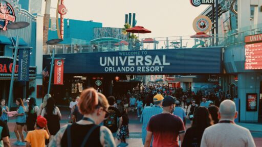 a crowd of people walking down a street to universal studios orlando resort