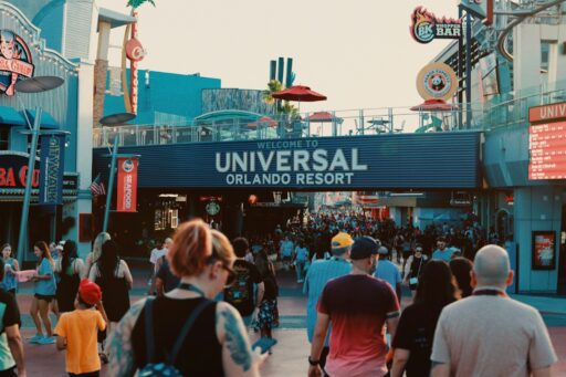 a crowd of people walking down a street to universal studios orlando resort