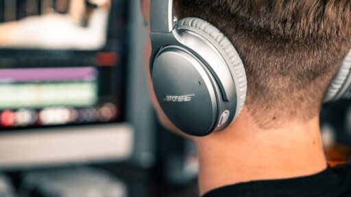 man in black and white crew neck shirt wearing bose headphones