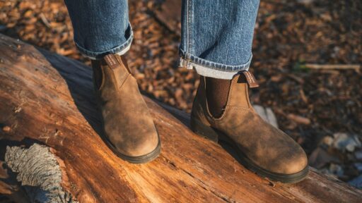 person in blue denim jeans and blundstone leather boots