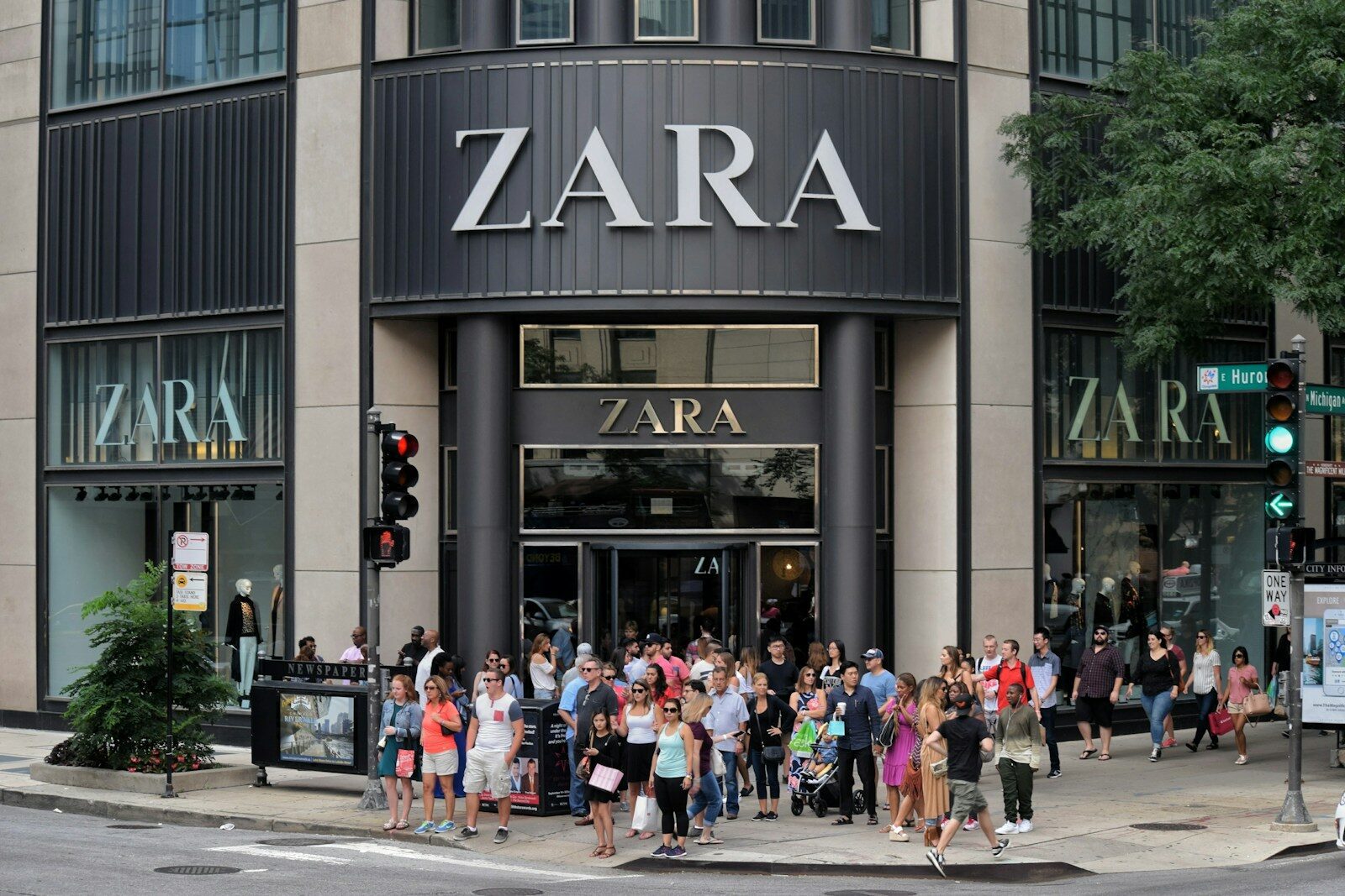 a group of people waiting to hear about zara first responder discount outside of store