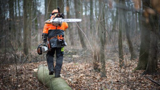 man walking with stihl chainsaw
