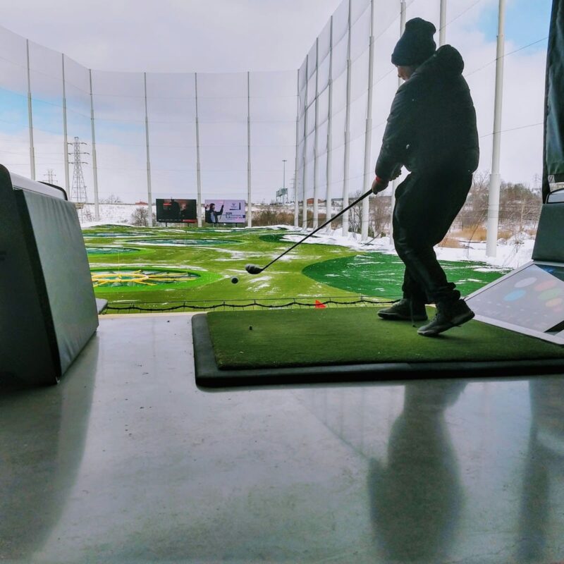 man playing topgolf during daytime