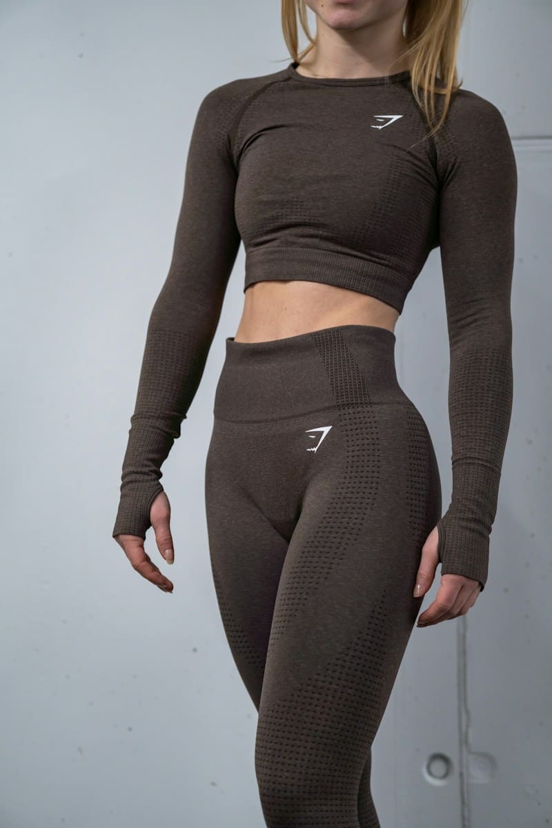 a woman in a gymshark brown top and leggings