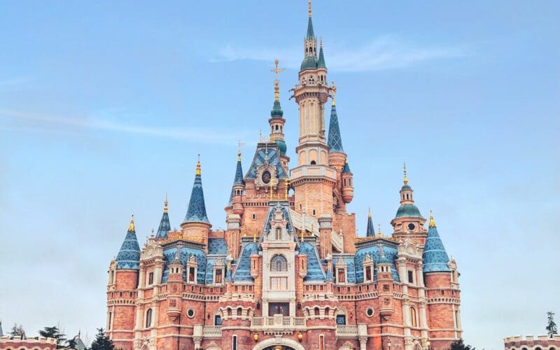 brown and blue concrete disney castle under blue sky during daytime