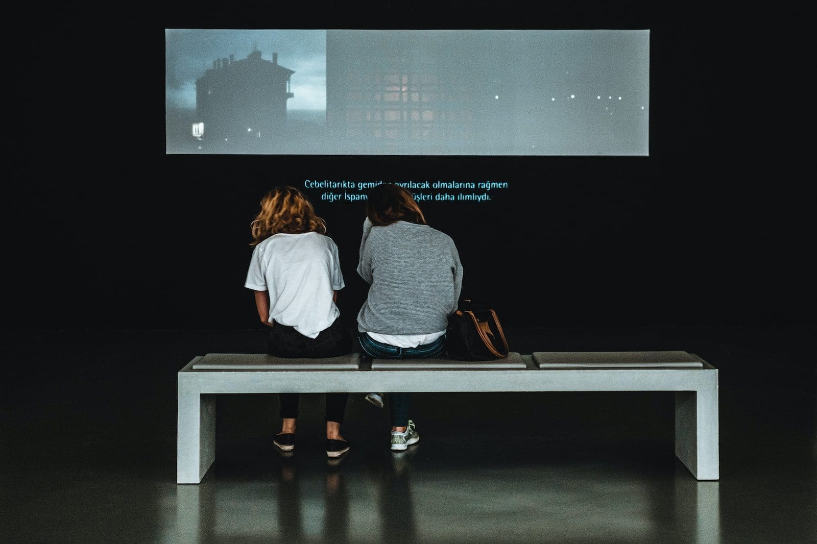 two women sitting on table at young at art museum