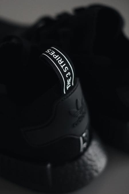 focus photography of Adidas NMD shoe