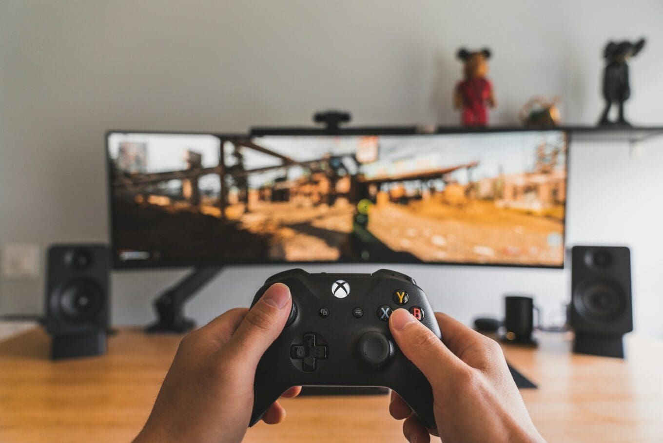 person holding black xbox game controller